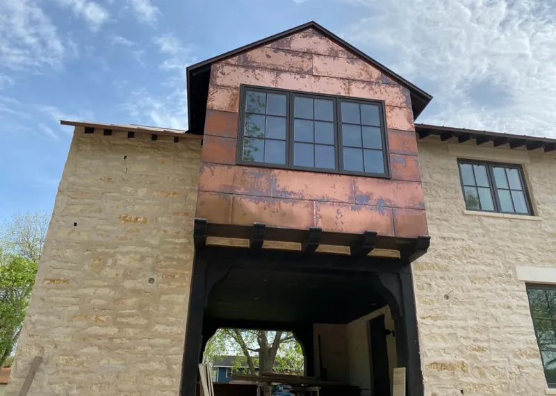 Copper metal panel facade on a stone building for Skylight Installation in Rockdale