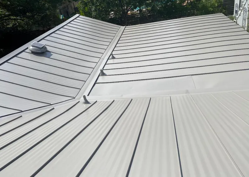 Solar attic fan installed on a metal roof for Roof Ventilation in Rockdale